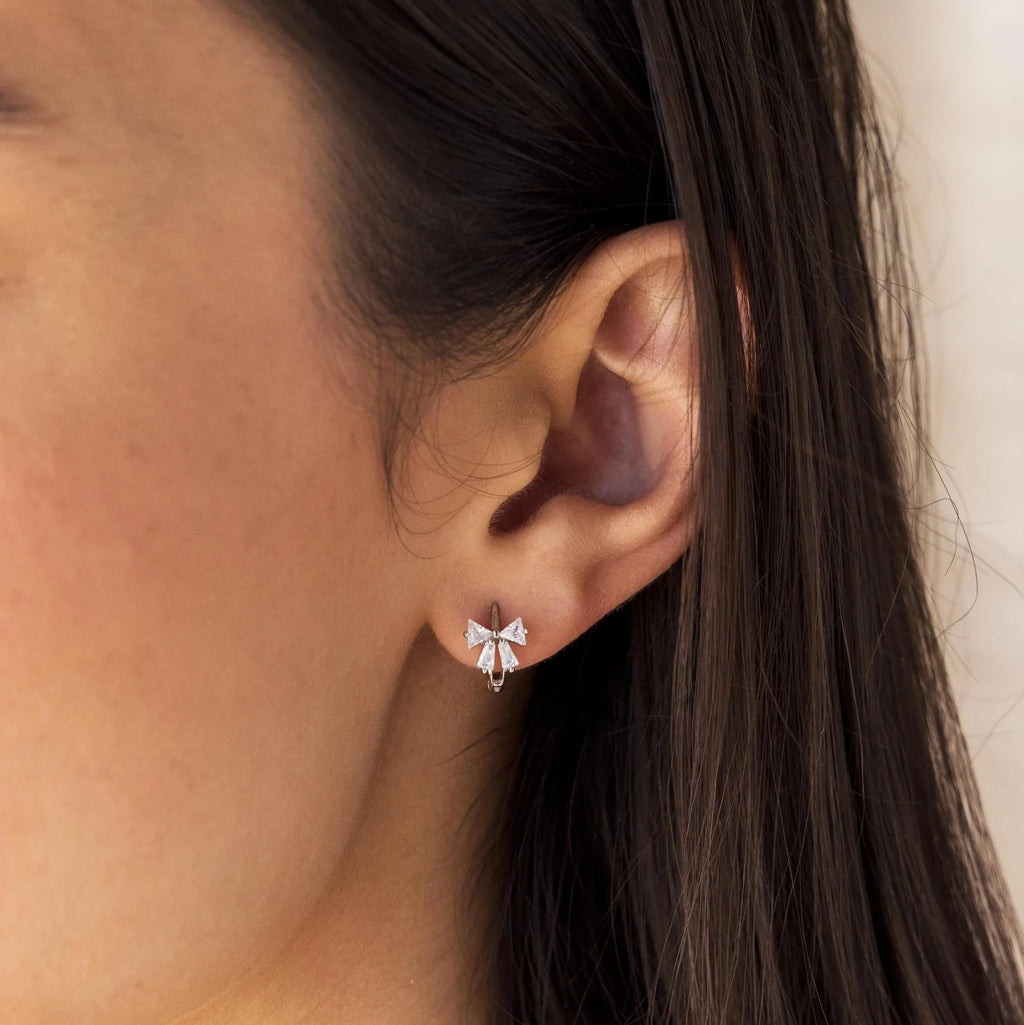 Little hoop earrings with a sparkly bow.