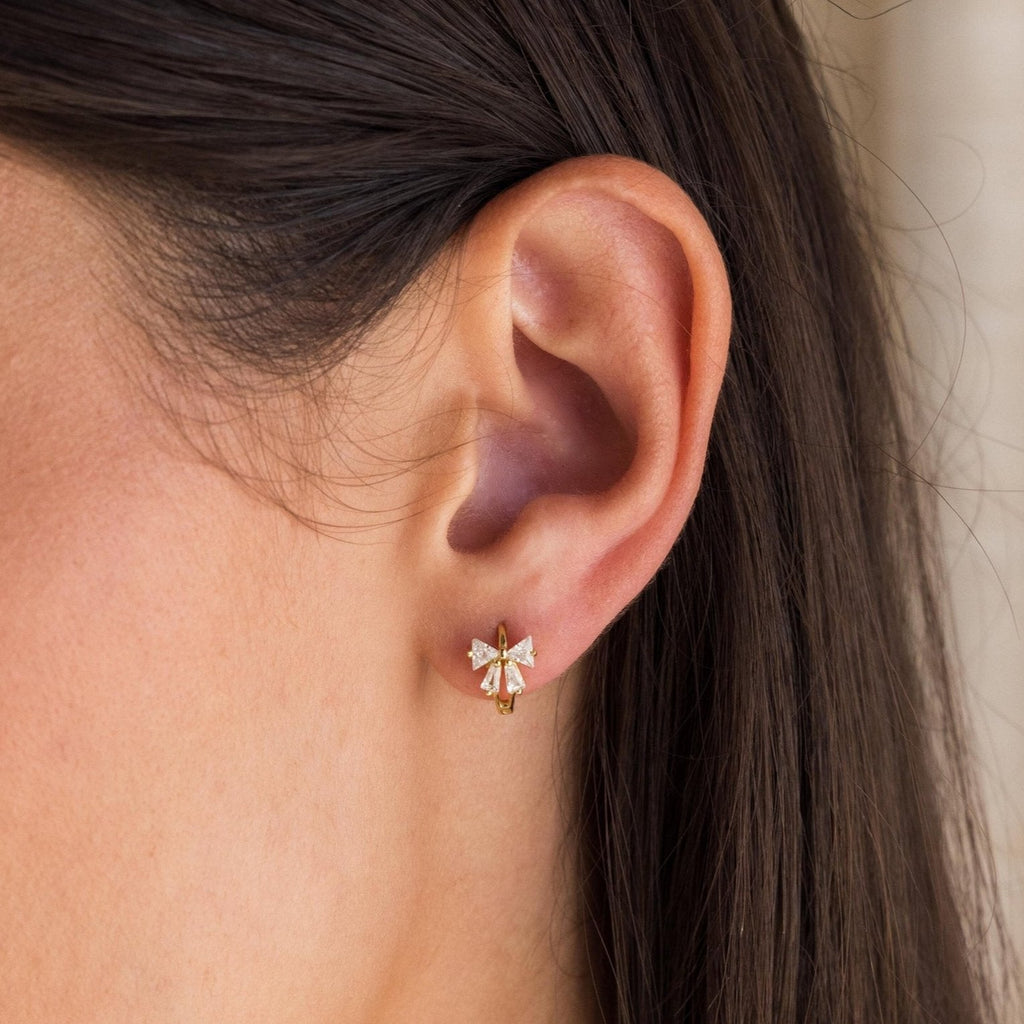 Little hoop earrings with a sparkly bow.