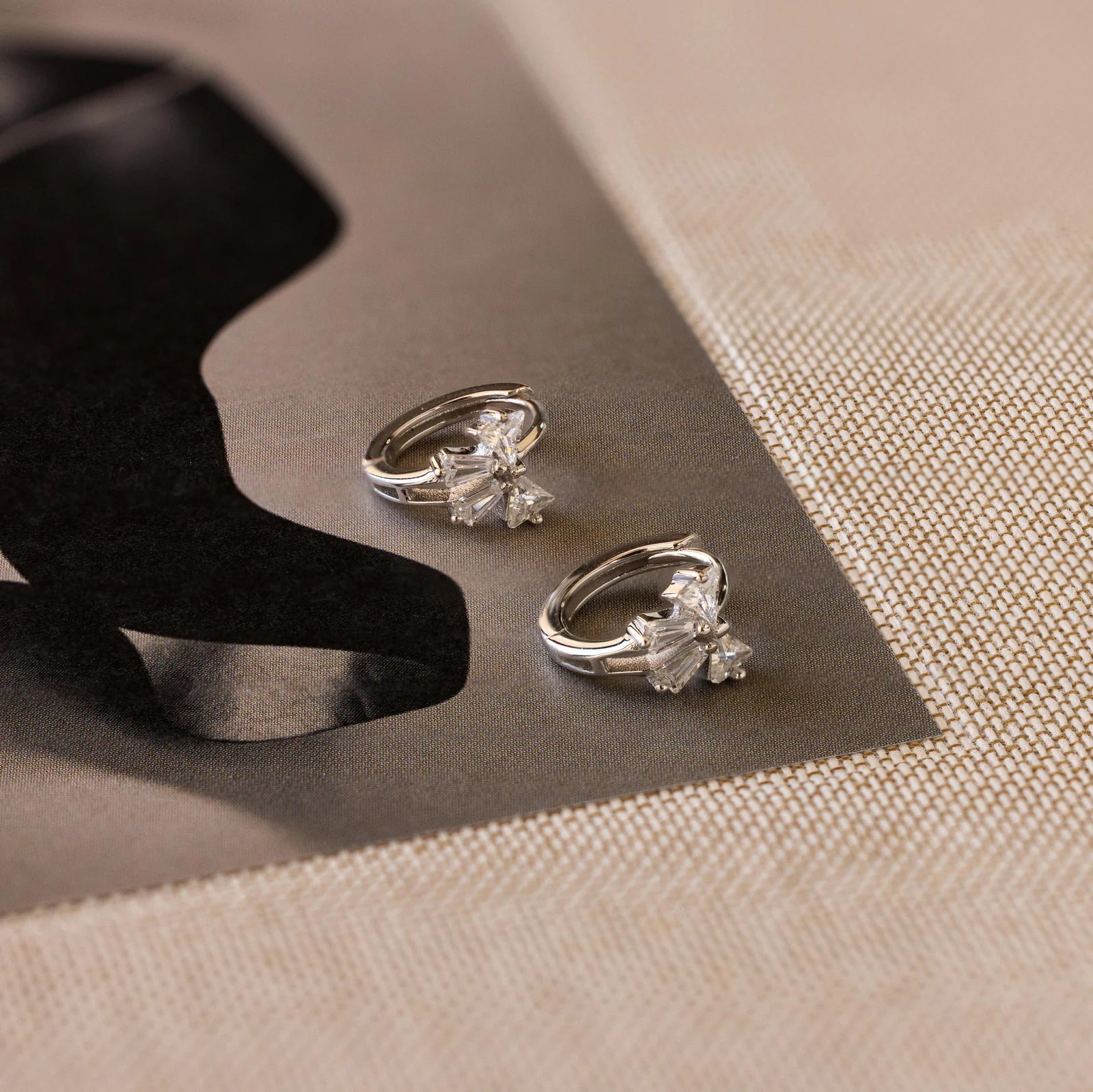 Little hoop earrings with a sparkly bow.