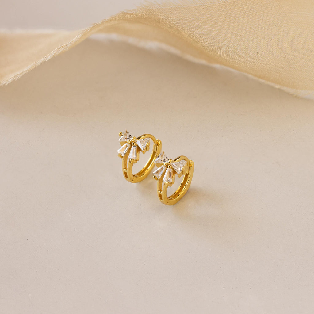 Little hoop earrings with a sparkly bow.